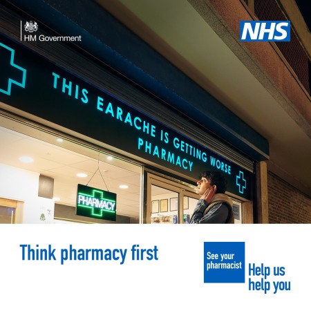 A person is standing outside a pharmacy holding the side of their face in discomfort. The sign above the pharmacy reads 'This earache is getting worse pharmacy'   A lower third box features in the bottom on the image. Text in the box reads: 'Think pharmac