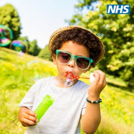 An image of a child blowing bubbles.  